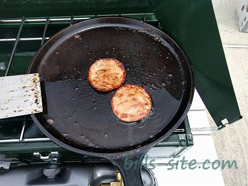 Frying up some Canadian bacon on our Coleman camp stove for our smoked hamburgers