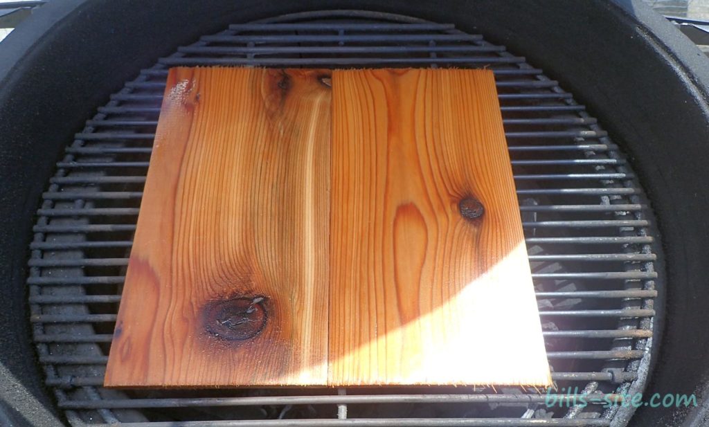 Two cedar grilling planks on the smoker grate