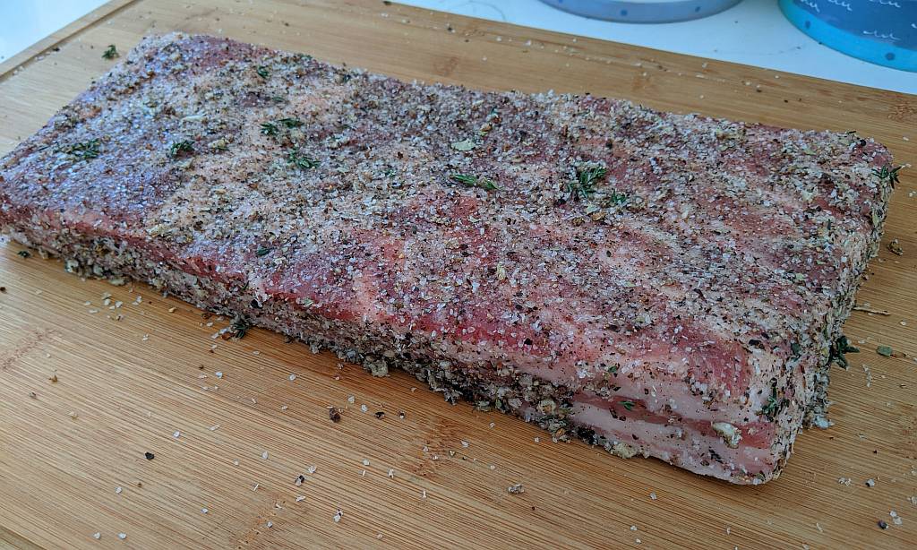 pork belly coated with cure and seasoning mix