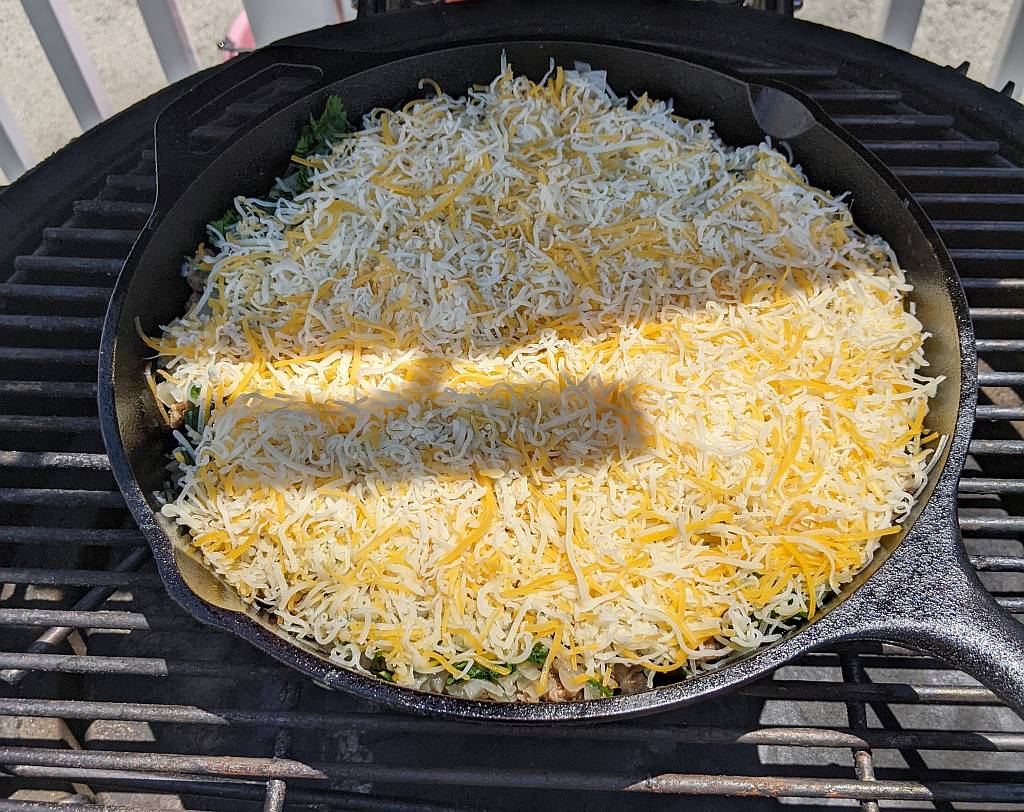 adding the chili relleno casserole ingredients in a skillet